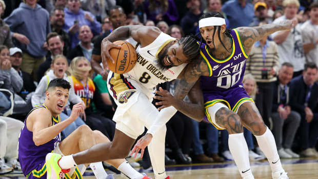 New Orleans Pelicans forward Naji Marshall (8) battle for the ball against Utah Jazz guard Jordan Clarkson (00) and forward Simone Fontecchio (16) during the second quarter at Delta Center.